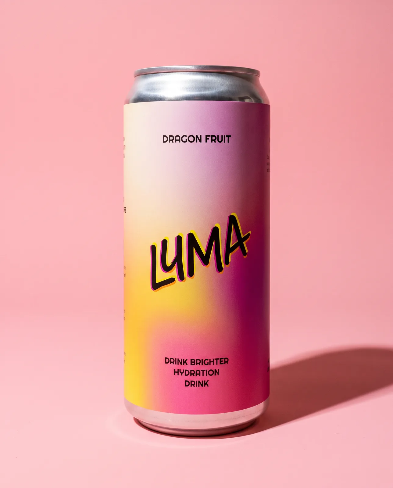 A Luma can square to camera on a pink ground, the aurora label running yellow to magenta