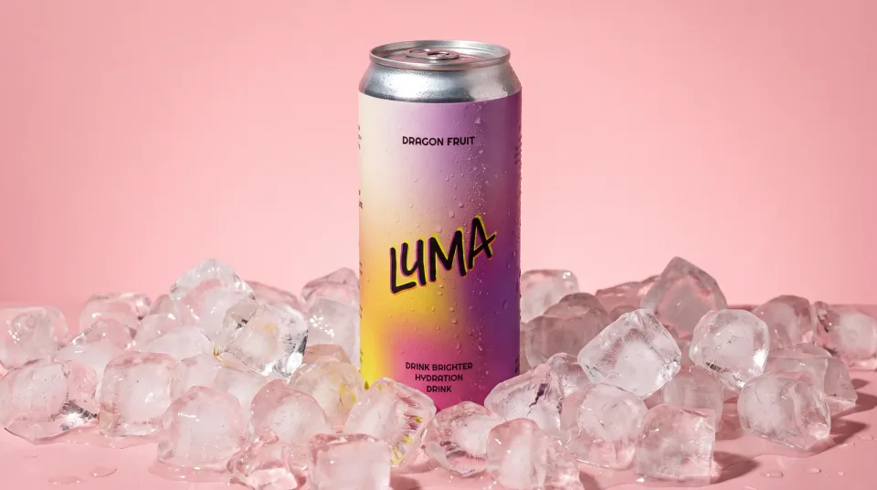 A Luma can standing in crushed ice on a pink ground