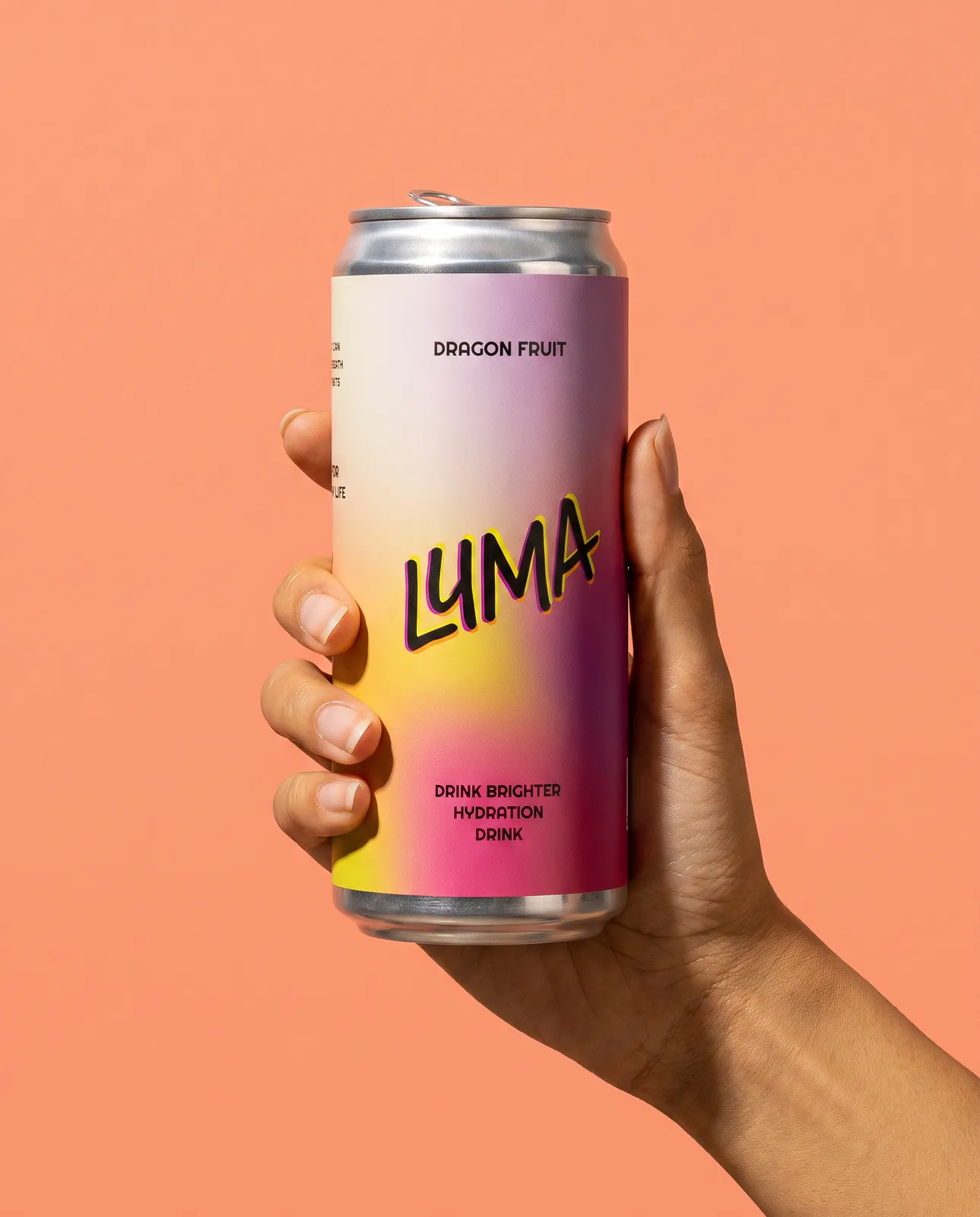 A hand holding a Luma can against a coral ground
