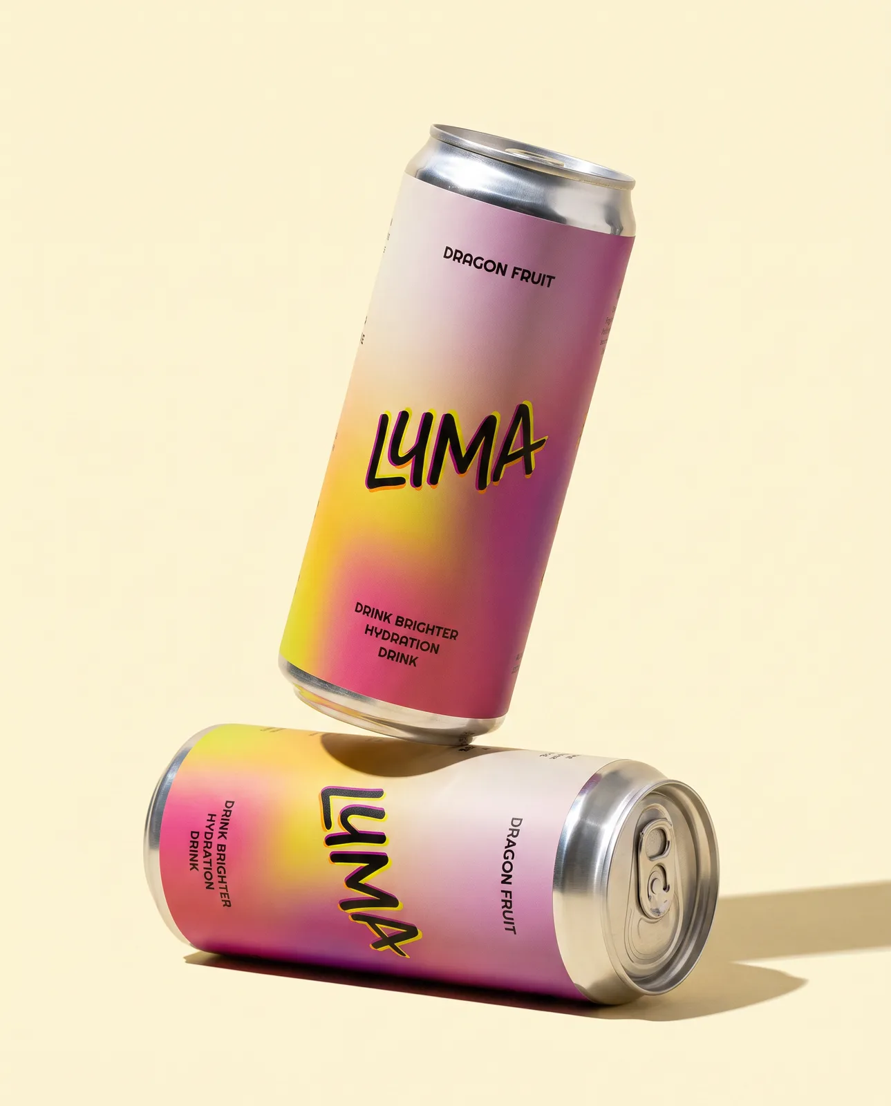 Two Luma cans on cream, one lying down and one balanced on its edge above it
